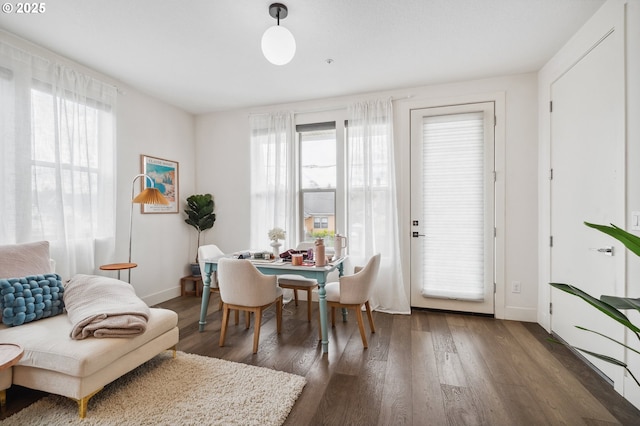 dining area with baseboards and wood finished floors