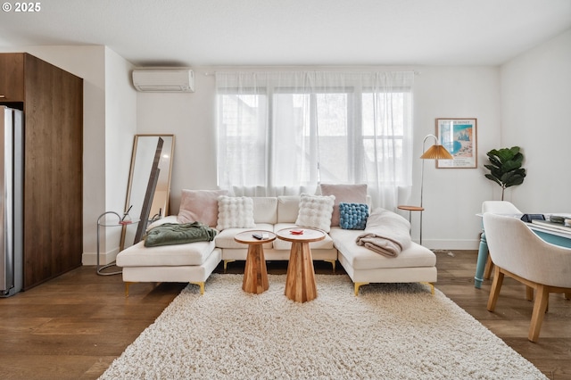 living room with baseboards, a wall unit AC, and dark wood-type flooring