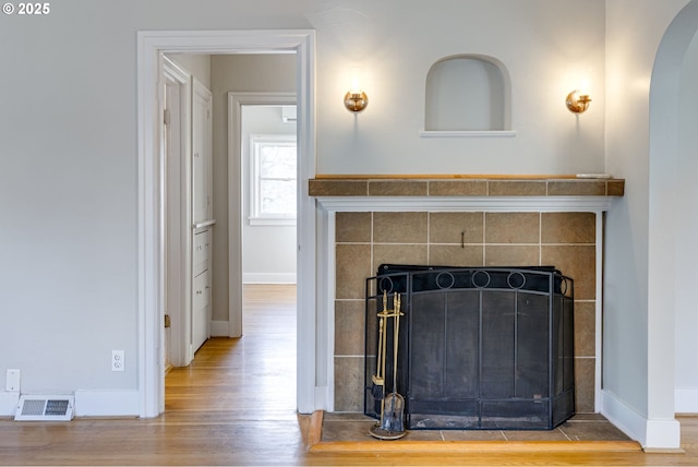 room details featuring hardwood / wood-style floors and a tile fireplace