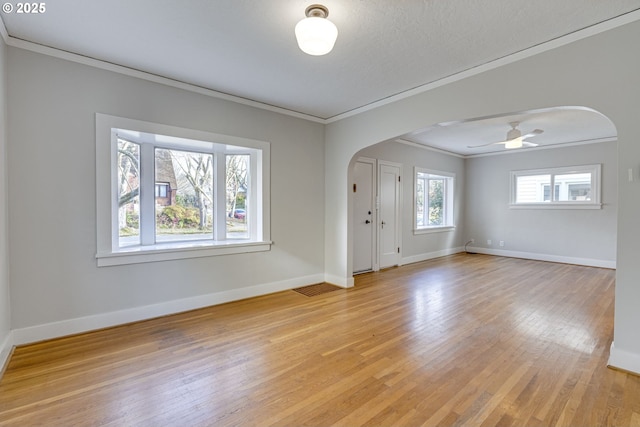 unfurnished room featuring crown molding, ceiling fan, light hardwood / wood-style flooring, and a textured ceiling