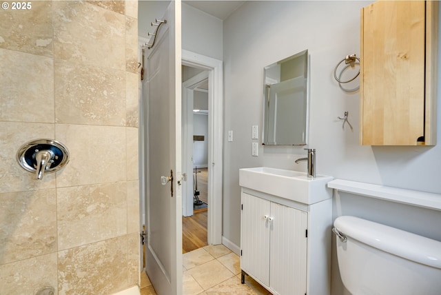 bathroom with tile patterned flooring, vanity, and toilet