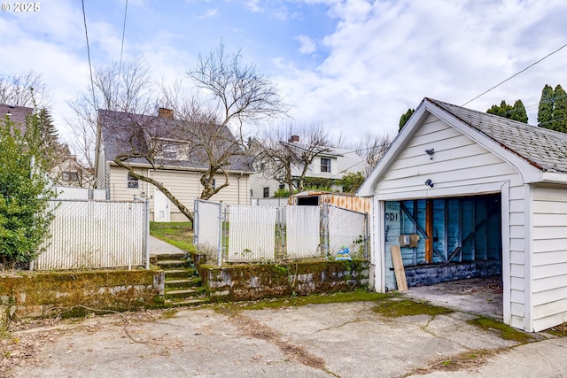 exterior space featuring an outbuilding and a garage