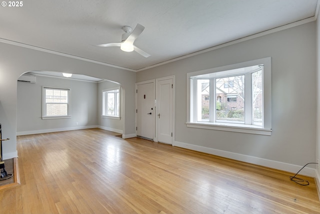 entryway featuring ornamental molding, a wall unit AC, ceiling fan, and light hardwood / wood-style flooring