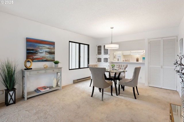 carpeted dining space with a textured ceiling and a baseboard radiator