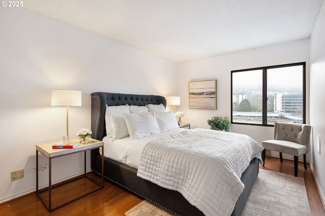 bedroom with dark wood-type flooring