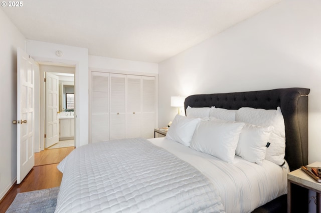 bedroom featuring light wood-type flooring and a closet