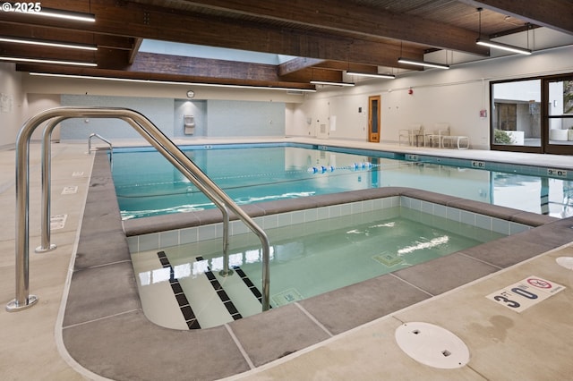 view of swimming pool featuring a skylight