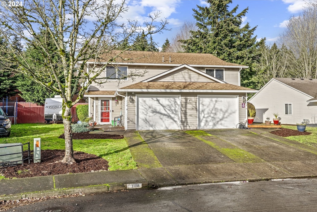 front of property featuring a garage and a front lawn