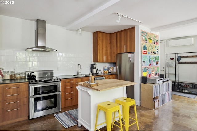 325 NE Graham St Unit 8, Portland, OR 97212 - kitchen featuring appliances with stainless steel finishes, finished concrete flooring, wall chimney range hood, and a sink