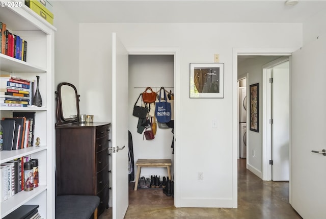 325 NE Graham St Unit 8, Portland, OR 97212 - corridor with stacked washing machine and dryer, finished concrete flooring, and baseboards