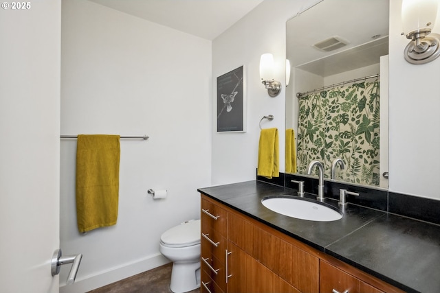 325 NE Graham St Unit 8, Portland, OR 97212 - full bath with toilet, baseboards, vanity, and a shower with shower curtain