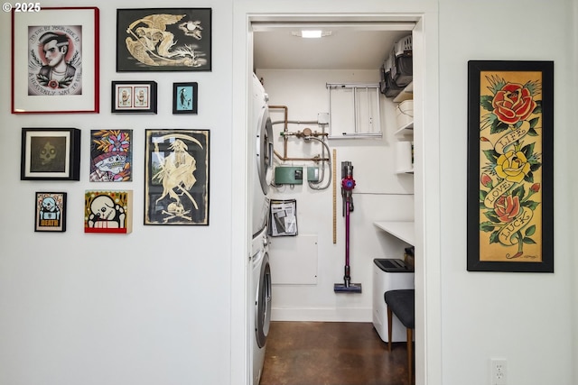 325 NE Graham St Unit 8, Portland, OR 97212 - laundry room with stacked washer and clothes dryer and baseboards