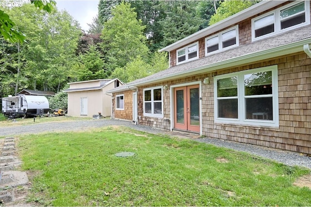 66663 Gunderson Rd, North Bend, OR 97459 - view of front of house featuring a front lawn, french doors, and roof with shingles