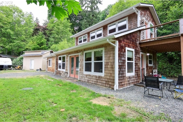 66663 Gunderson Rd, North Bend, OR 97459 - view of front of house with a front yard, a wooden deck, and french doors