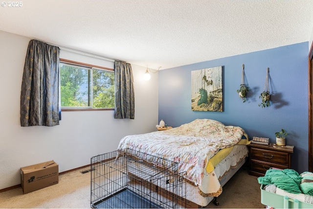 carpeted bedroom featuring a textured ceiling