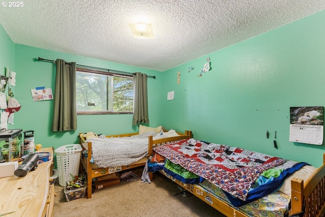 bedroom featuring carpet flooring and a textured ceiling