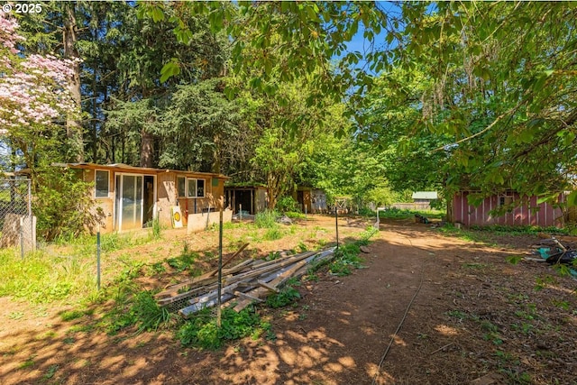view of yard with fence and an outbuilding