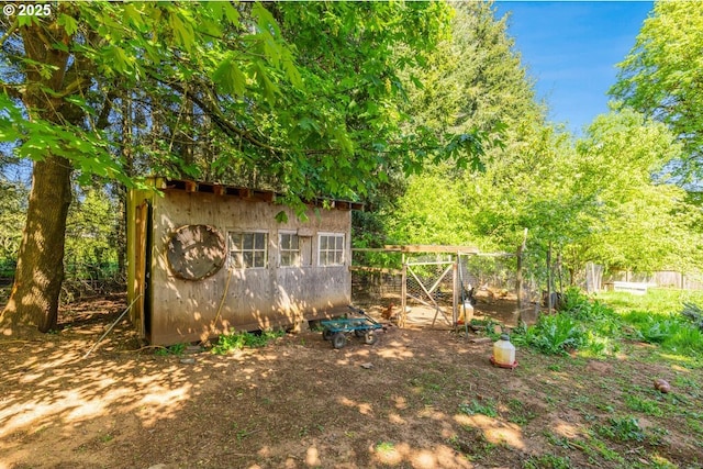 view of shed with fence