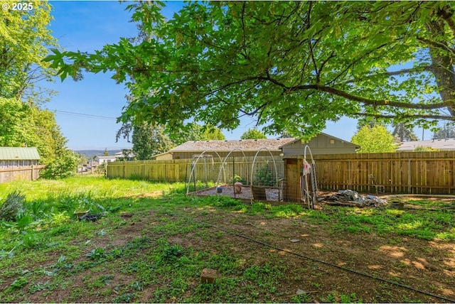 view of yard featuring a fenced backyard and a vegetable garden