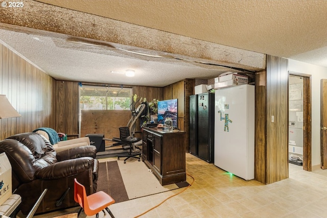 office area with a textured ceiling and wood walls