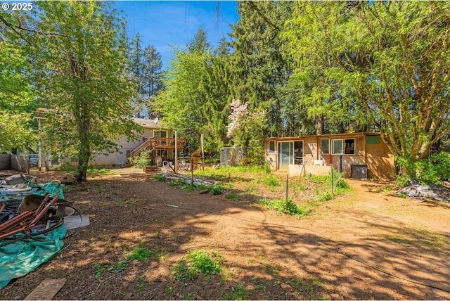 view of yard with a wooden deck and stairway