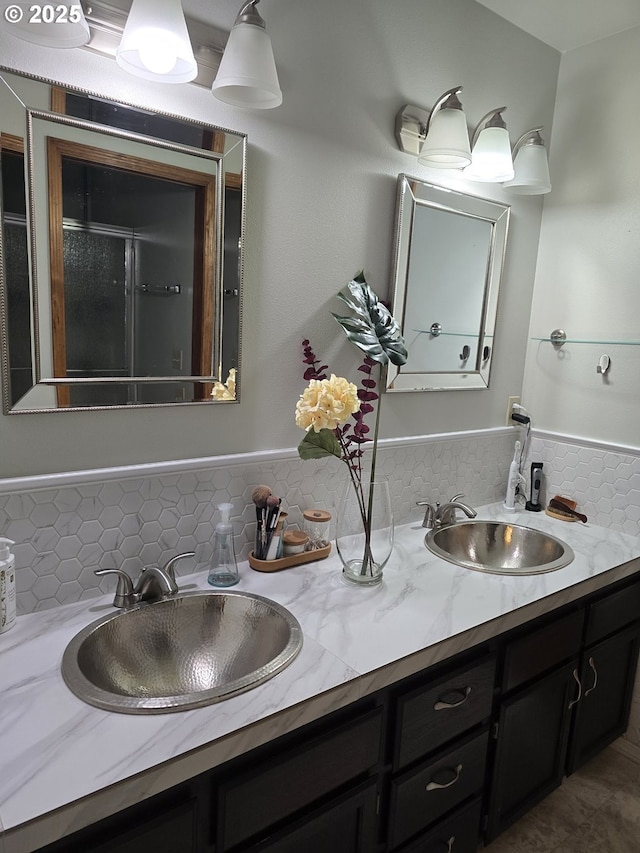 bathroom with a shower with door, decorative backsplash, and vanity