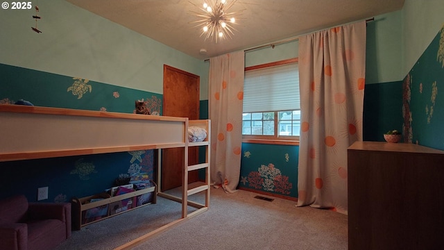 bedroom featuring an inviting chandelier and carpet floors