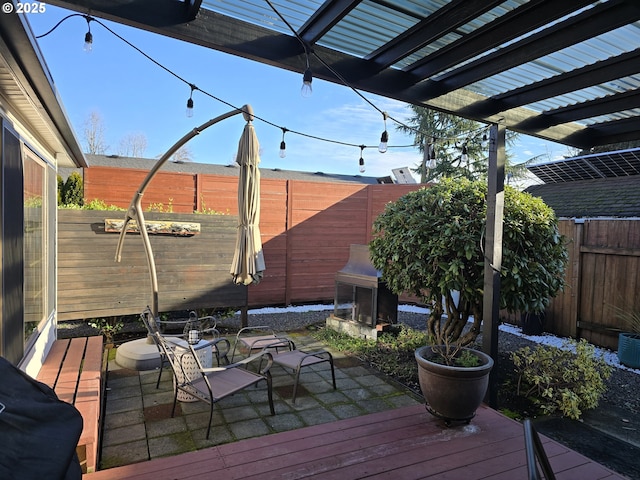 wooden terrace featuring a pergola and a patio area