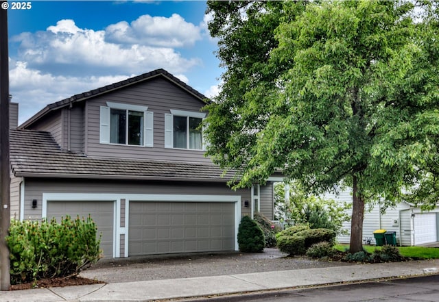 15463 NW Andalusian Way, Portland, OR 97229 - view of front of house featuring a garage, driveway, and a tile roof