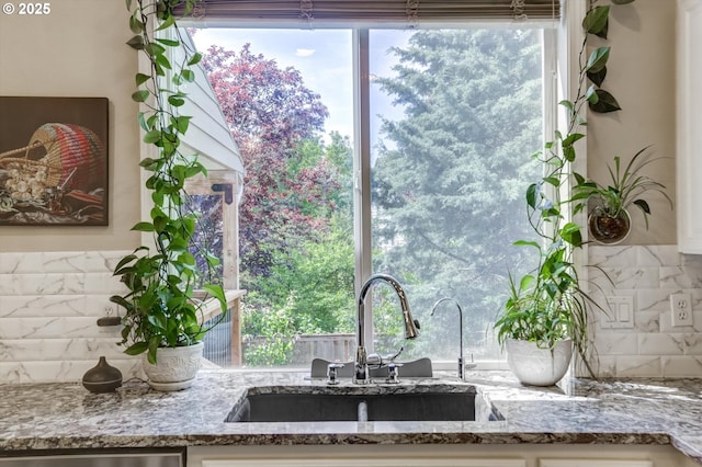 15463 NW Andalusian Way, Portland, OR 97229 - kitchen with a sink, tasteful backsplash, light stone countertops, and stainless steel dishwasher