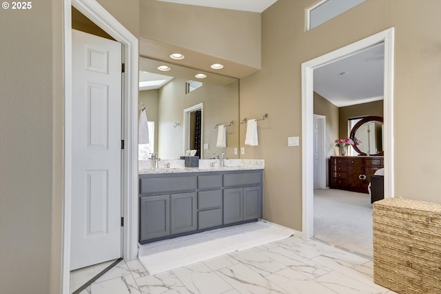 15463 NW Andalusian Way, Portland, OR 97229 - bathroom with marble look tiles, double vanity, recessed lighting, and baseboards