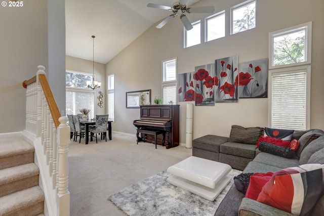 15463 NW Andalusian Way, Portland, OR 97229 - living area with high vaulted ceiling, a chandelier, a ceiling fan, carpet flooring, and baseboards