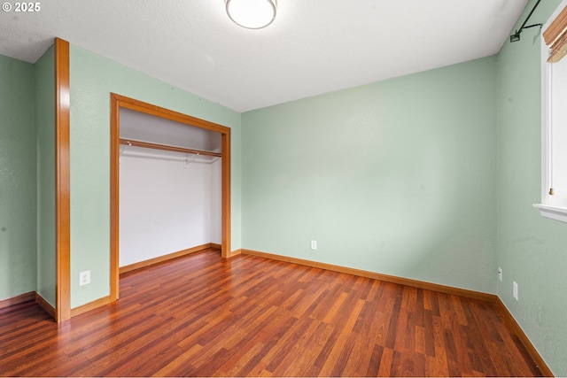 1313 Wakeman Ln, Gearhart, OR 97138 - unfurnished bedroom with wood finished floors, a closet, and baseboards
