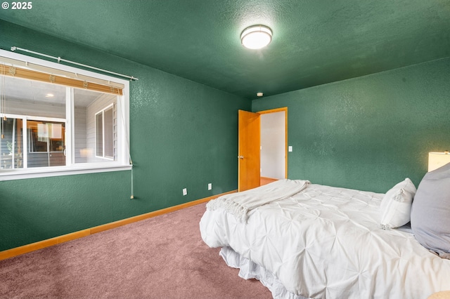 1313 Wakeman Ln, Gearhart, OR 97138 - bedroom featuring a textured wall, carpet flooring, and baseboards