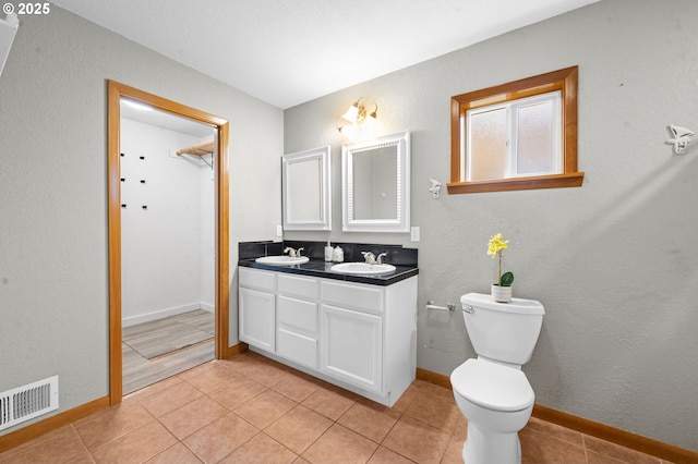 1313 Wakeman Ln, Gearhart, OR 97138 - full bathroom featuring double vanity, baseboards, toilet, and tile patterned floors