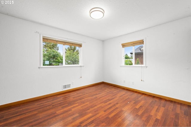 1313 Wakeman Ln, Gearhart, OR 97138 - spare room featuring plenty of natural light, wood finished floors, and baseboards