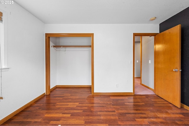 1313 Wakeman Ln, Gearhart, OR 97138 - unfurnished bedroom featuring wood finished floors, a closet, and baseboards