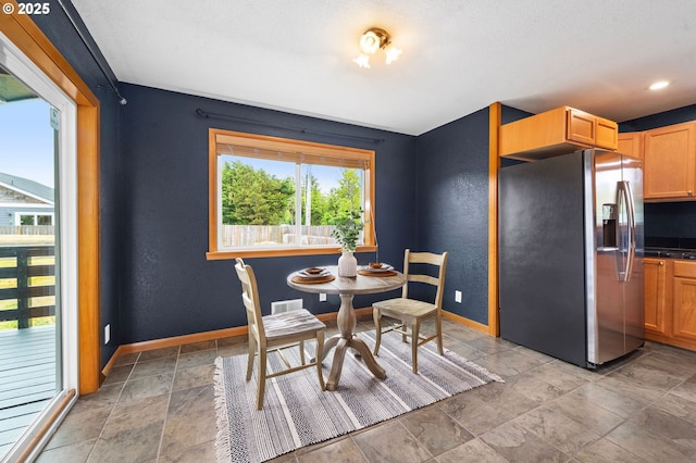 1313 Wakeman Ln, Gearhart, OR 97138 - dining area featuring baseboards and light stone finish flooring