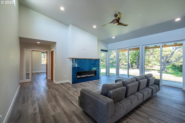 760 Carter St SW, Bandon, OR 97411 - living area with ceiling fan, baseboards, a tiled fireplace, wood finished floors, and recessed lighting