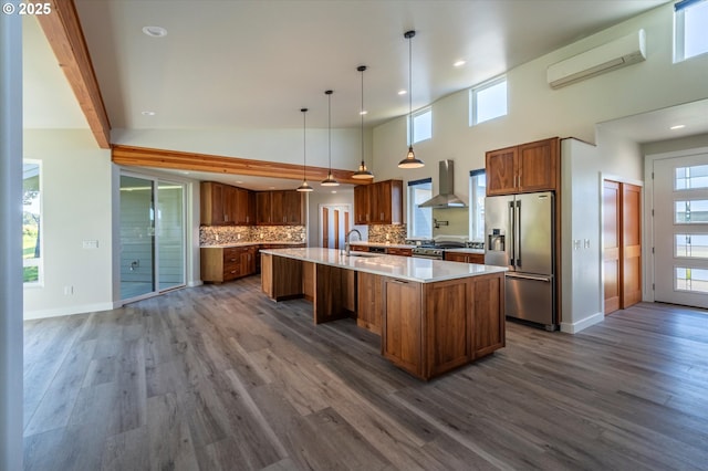 760 Carter St SW, Bandon, OR 97411 - kitchen with high end appliances, a sink, wall chimney exhaust hood, brown cabinets, and a wall mounted AC