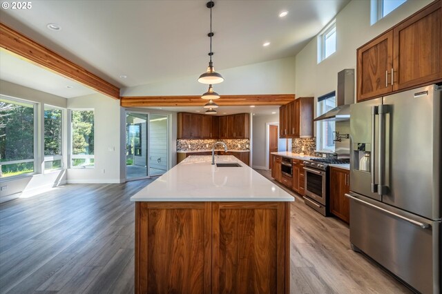 760 Carter St SW, Bandon, OR 97411 - kitchen with high end appliances, a sink, tasteful backsplash, light wood-style flooring, and recessed lighting