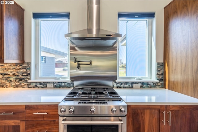 760 Carter St SW, Bandon, OR 97411 - kitchen with wall chimney range hood, gas range, light countertops, and backsplash
