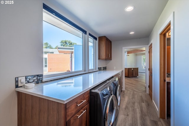 760 Carter St SW, Bandon, OR 97411 - laundry area with cabinet space, wood finished floors, washer and clothes dryer, recessed lighting, and baseboards