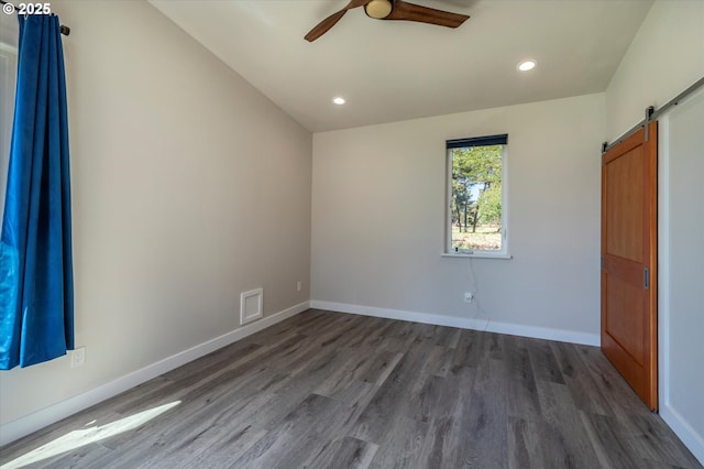 760 Carter St SW, Bandon, OR 97411 - unfurnished bedroom featuring a barn door, dark wood-style flooring, baseboards, recessed lighting, and ceiling fan