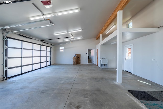 760 Carter St SW, Bandon, OR 97411 - garage featuring a garage door opener and a sink