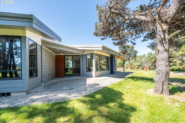 760 Carter St SW, Bandon, OR 97411 - rear view of house featuring a patio area and a lawn