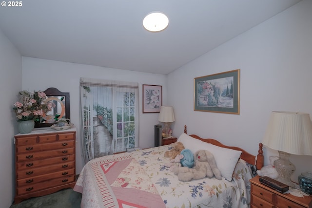 carpeted bedroom featuring lofted ceiling