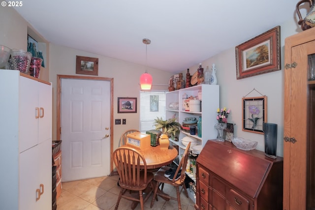 tiled dining room with vaulted ceiling