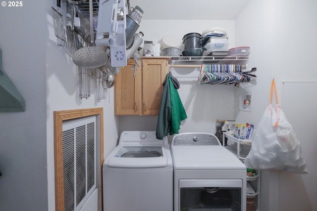 laundry room featuring cabinets and washing machine and clothes dryer