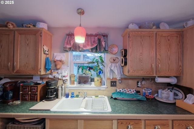 kitchen featuring decorative light fixtures and sink